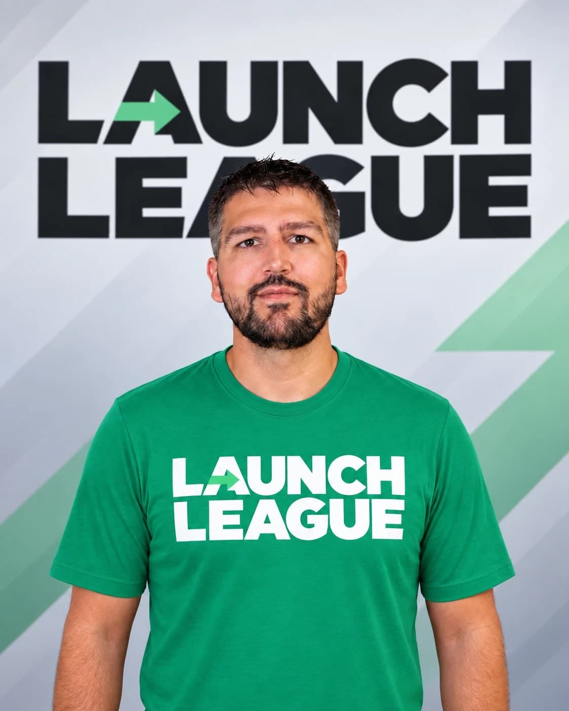Nick Gonzalez, Founder of Launch League, in a green Launch League t-shirt in front of the Launch League wordmark